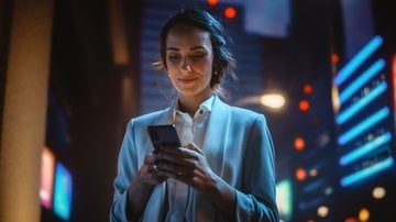 Mulher jovem usando o celular - gorodenkoff/iStock