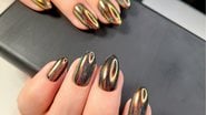 Unhas decoradas metalizadas são umas das principais tendências de nail art para 2023. - Imagem: OleJohny/iStock