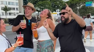 Turistas com capirinhas em mãos dançando, ao lado de influenciador brasileiro, no calçadão de copacabana.