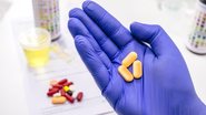 Profissional da saúde segurando medicamentos.