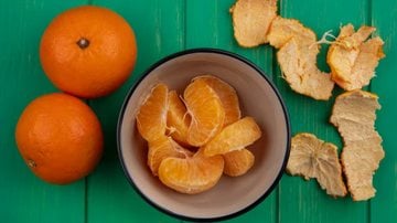cascas de laranja ao lado de bagaços da fruta.