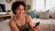 mulher usando celular e rindo.