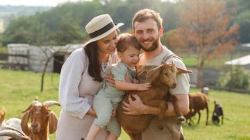 família sorrindo em visita à fazenda.