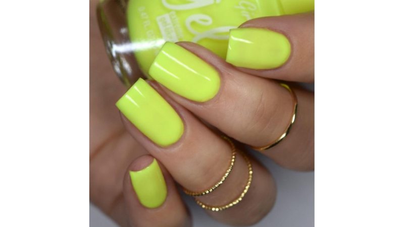 Unhas neon amarelas.